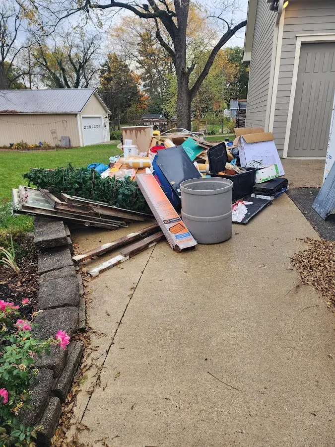 Dumpster being loaded with debris for Roofing Dumpster Rental in Irondequoit